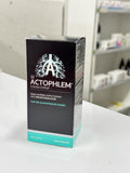 Actophlem cough syrup packaging on a white surface with a blurred background