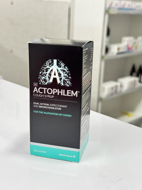 Actophlem cough syrup packaging on a white surface with a blurred background