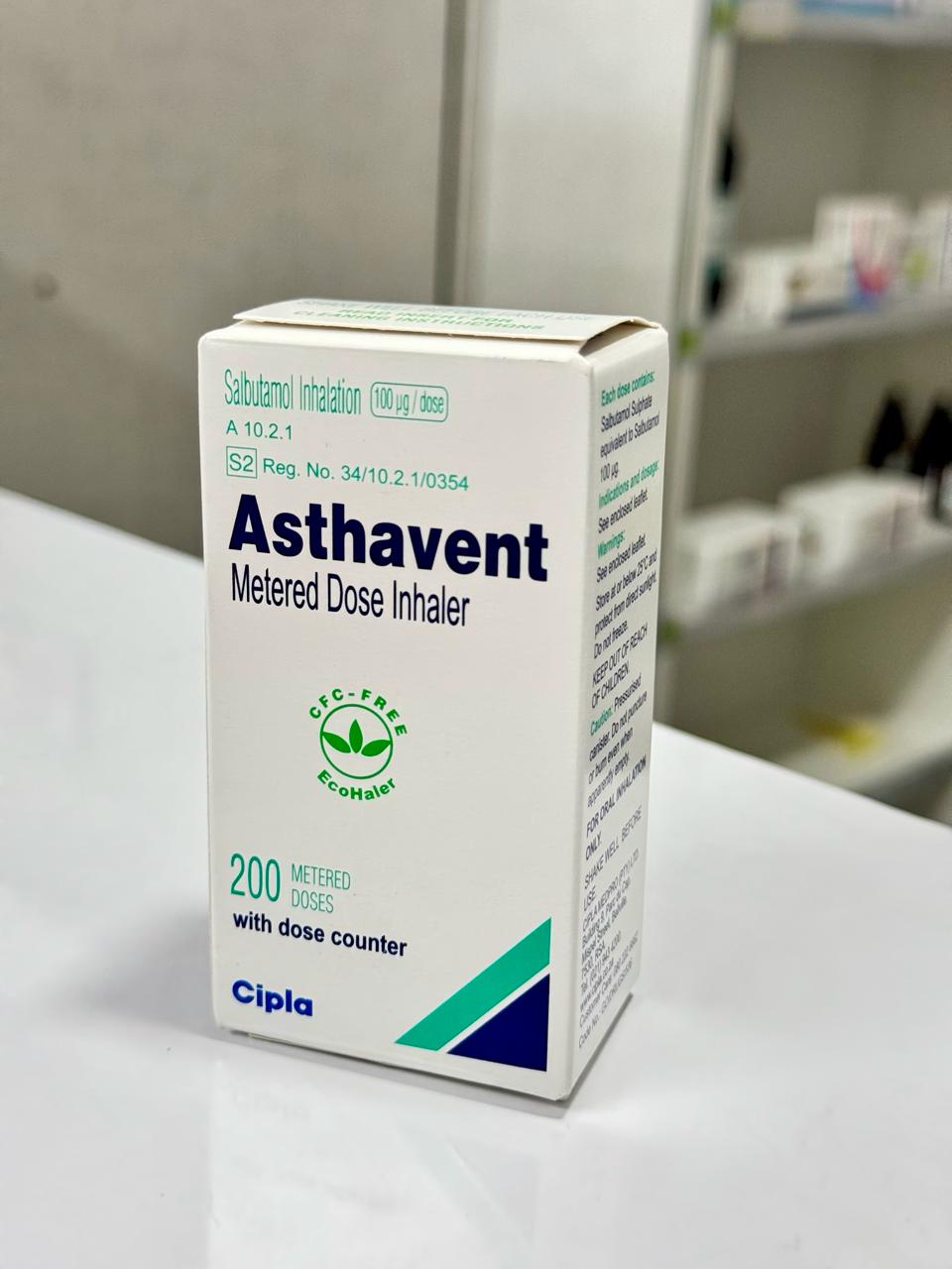 Box of Asthavent Metered Dose Inhaler on a white surface with a blurred background