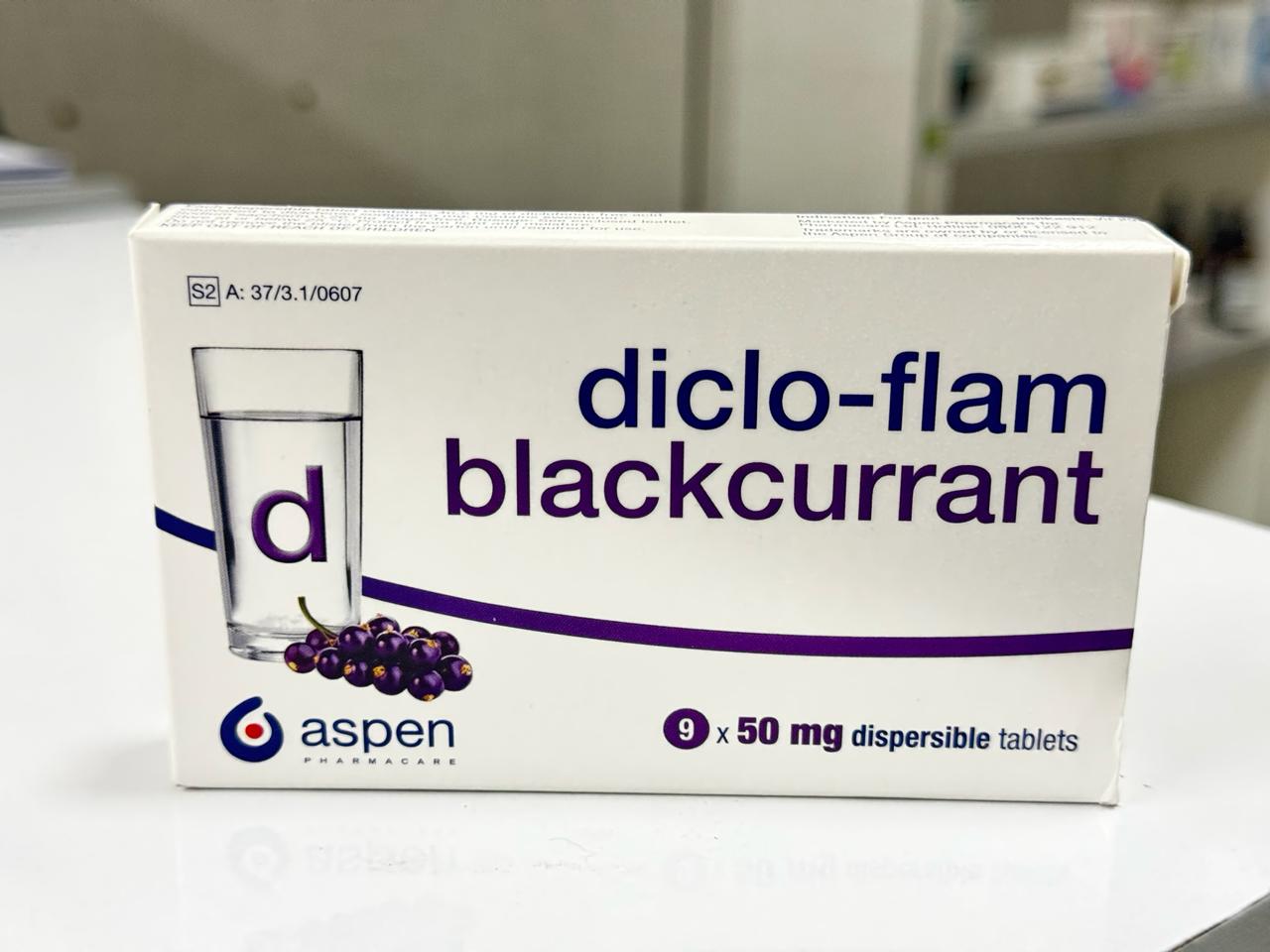 Box of diclo-flam blackcurrant tablets by Aspen on a white surface.